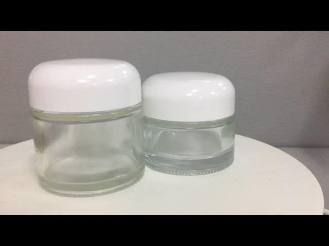 Продукт стекла OEM крышки круглой вершины OEM стеклянного опарника Skincare 50g 70g сливк косметического упаковывая лидирующий видео